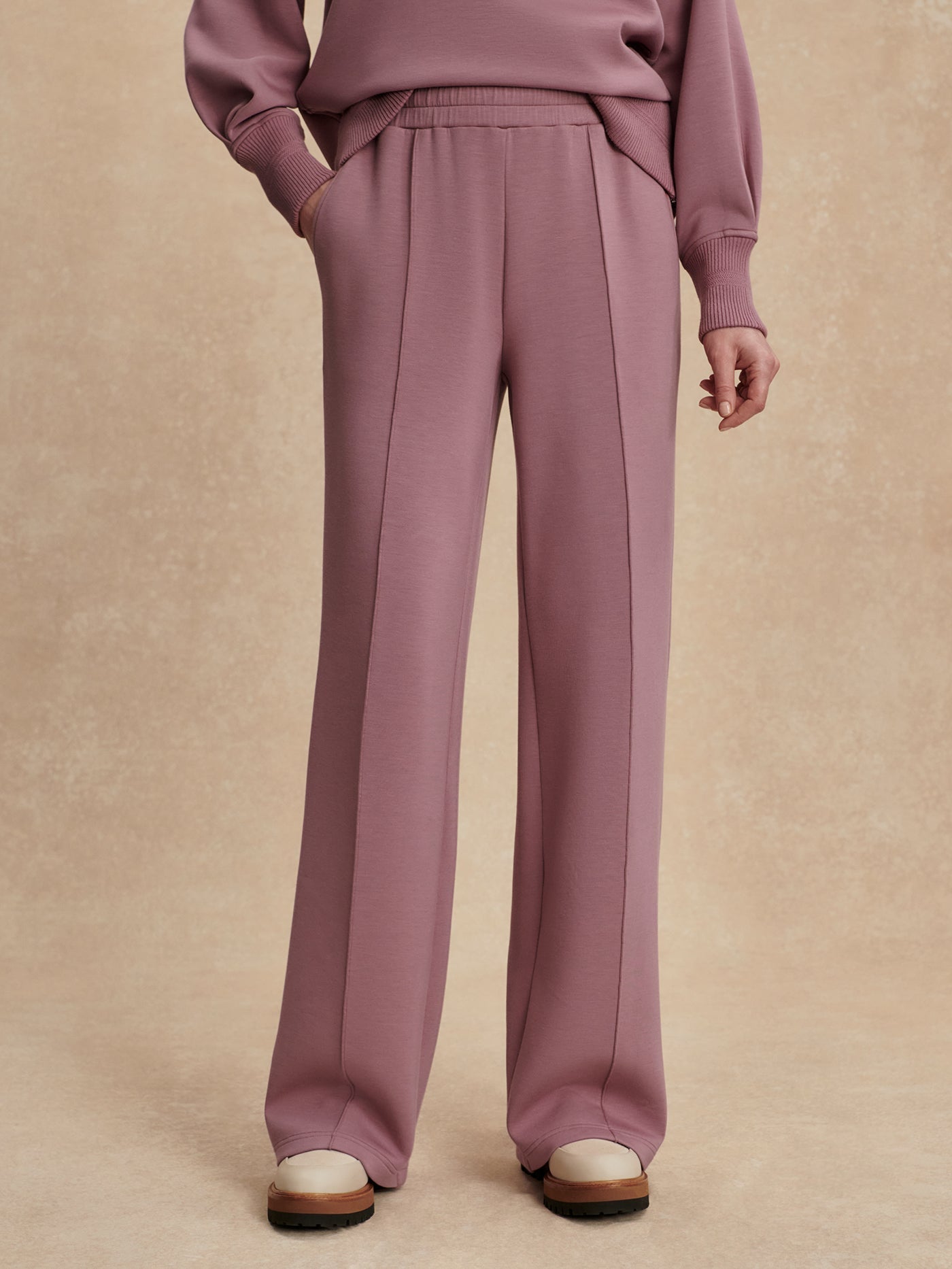 Model wearing the Varley The Wide Leg Pant 30" in Wistful Mauve, front view.