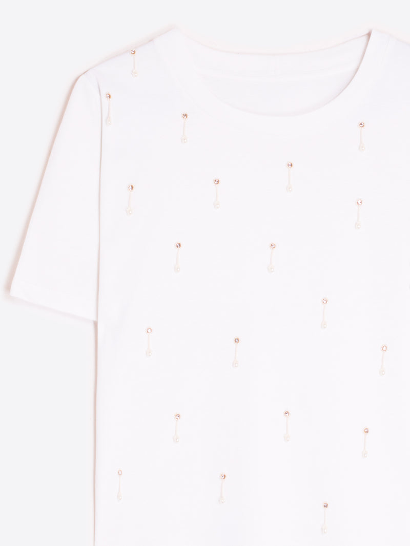 Close-up of the Vilagallo white T-shirt with rhinestone embellishments on a white background.