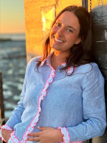 Model wearing the Vilagallo Pia Shirt in baby blue, front view, with white ruffle trim accented in pink.