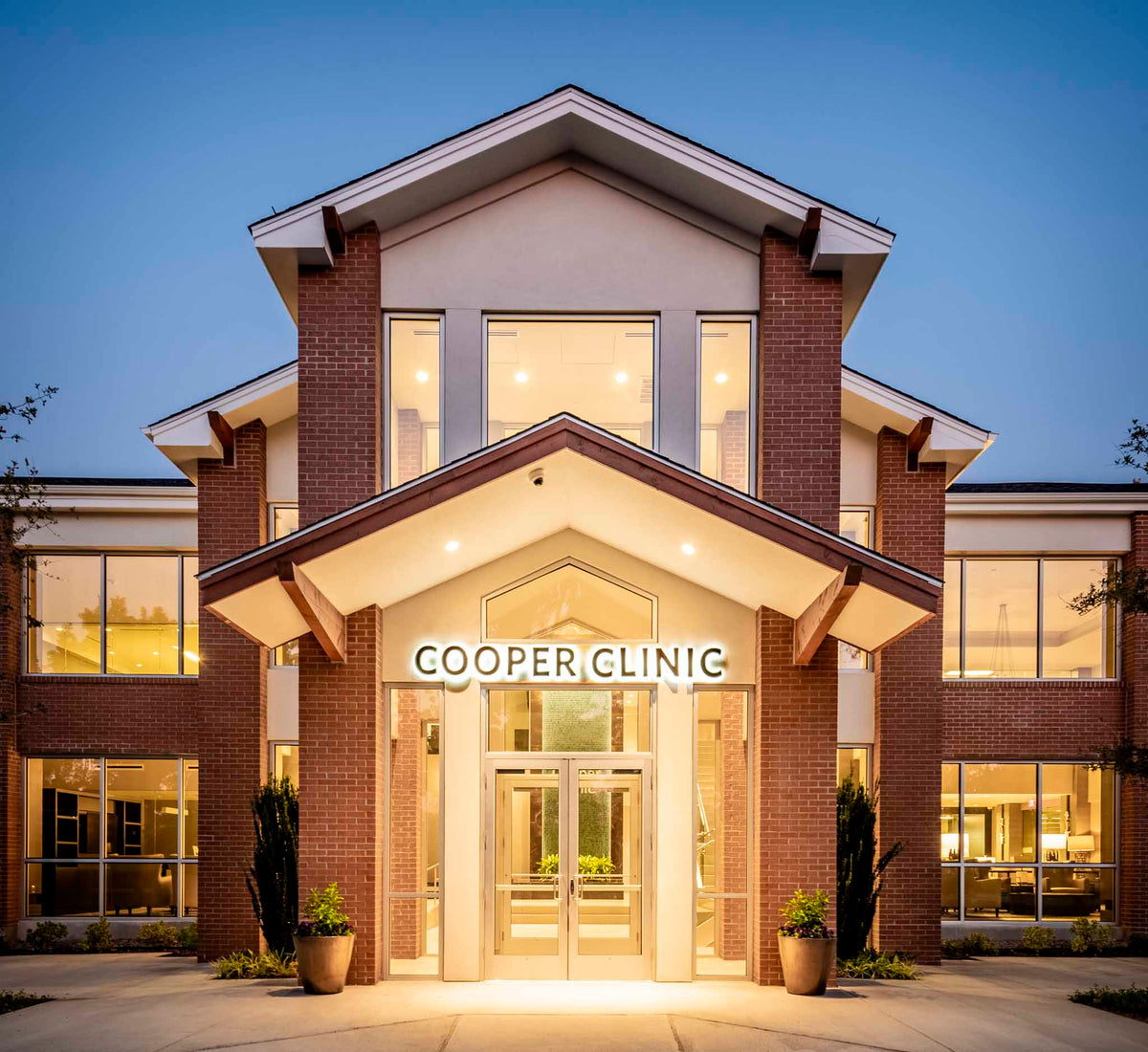 Front of Cooper Clinic building at dusk with lights.