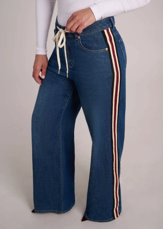 Close-up of the Carina High Rise jeans showing the drawstring waistband, front pocket and striped side seam.