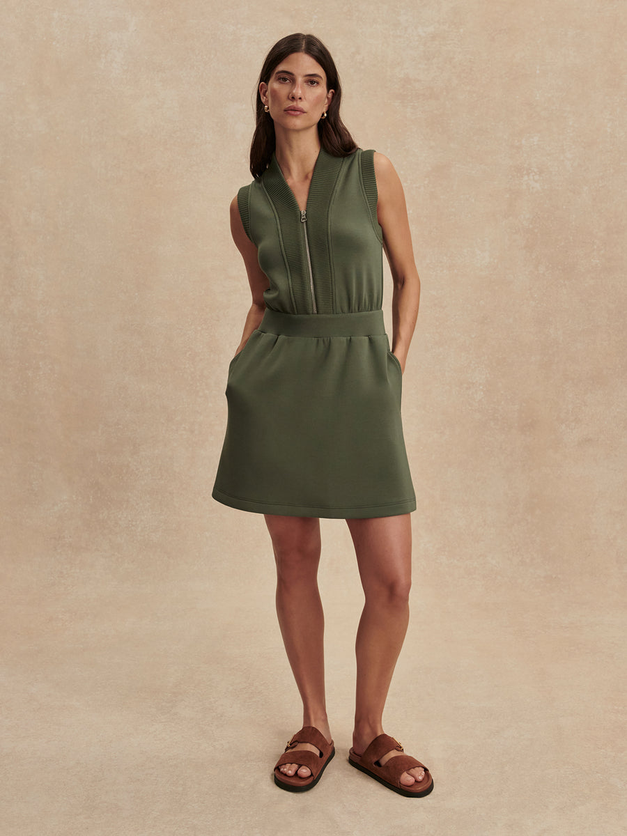 Model wearing the Varley Polyanna Half-Zip Dress in Thyme, front view.