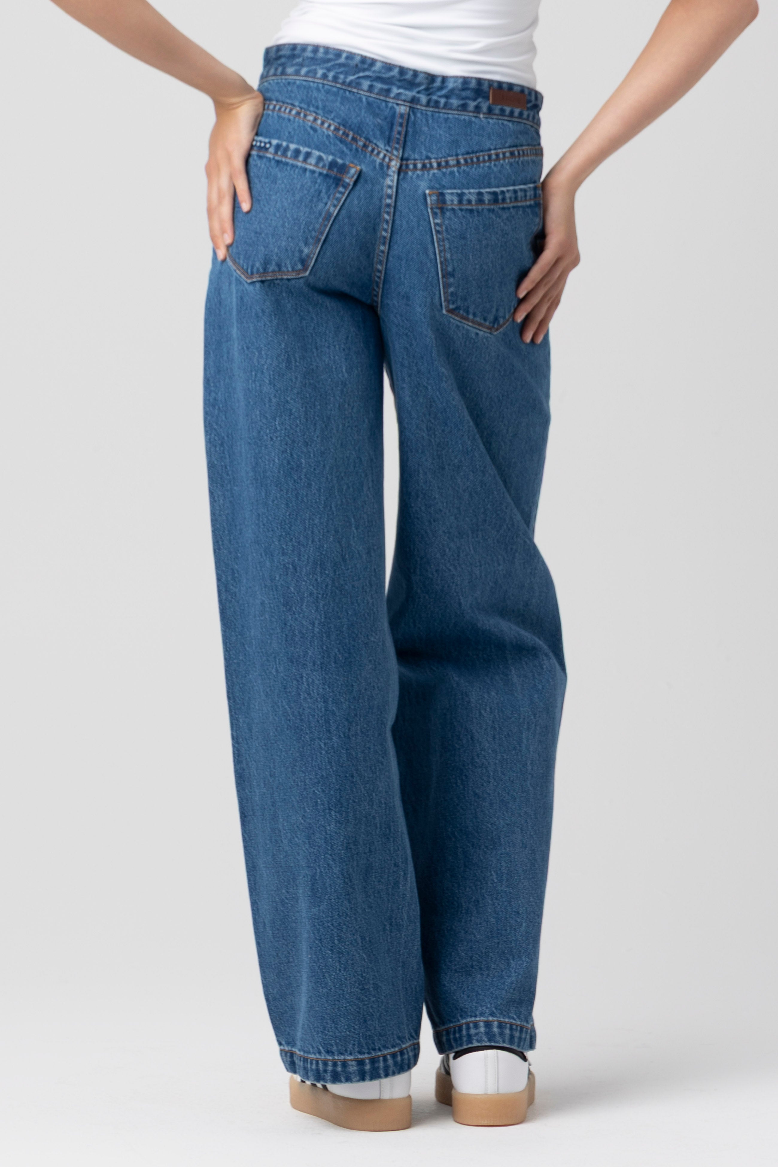 Back view of a model wearing the BLANKNYC Hands Down Pant in the Hands Down wash.