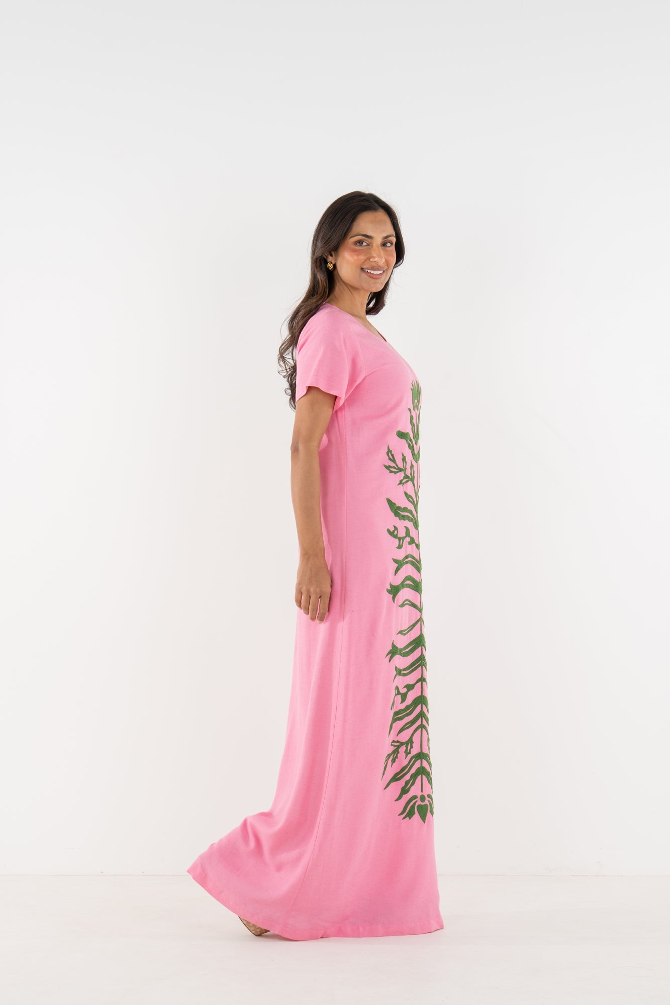 Side view of a model wearing the Emily McCarthy Cornelia Dress in Rosé.