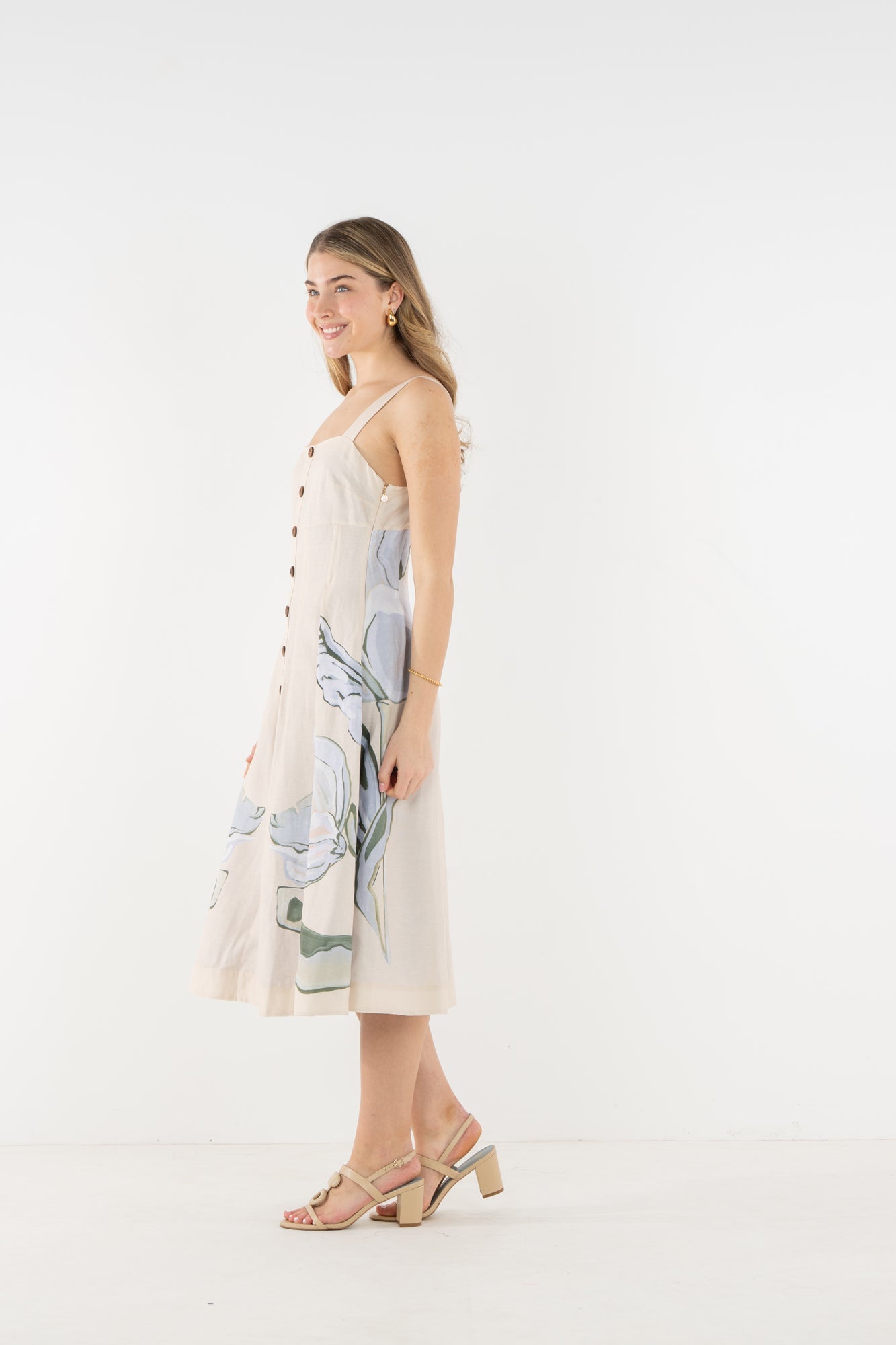 Side view of a model wearing the Emily McCarthy Constance Midi Dress in the Lavender Fields print.