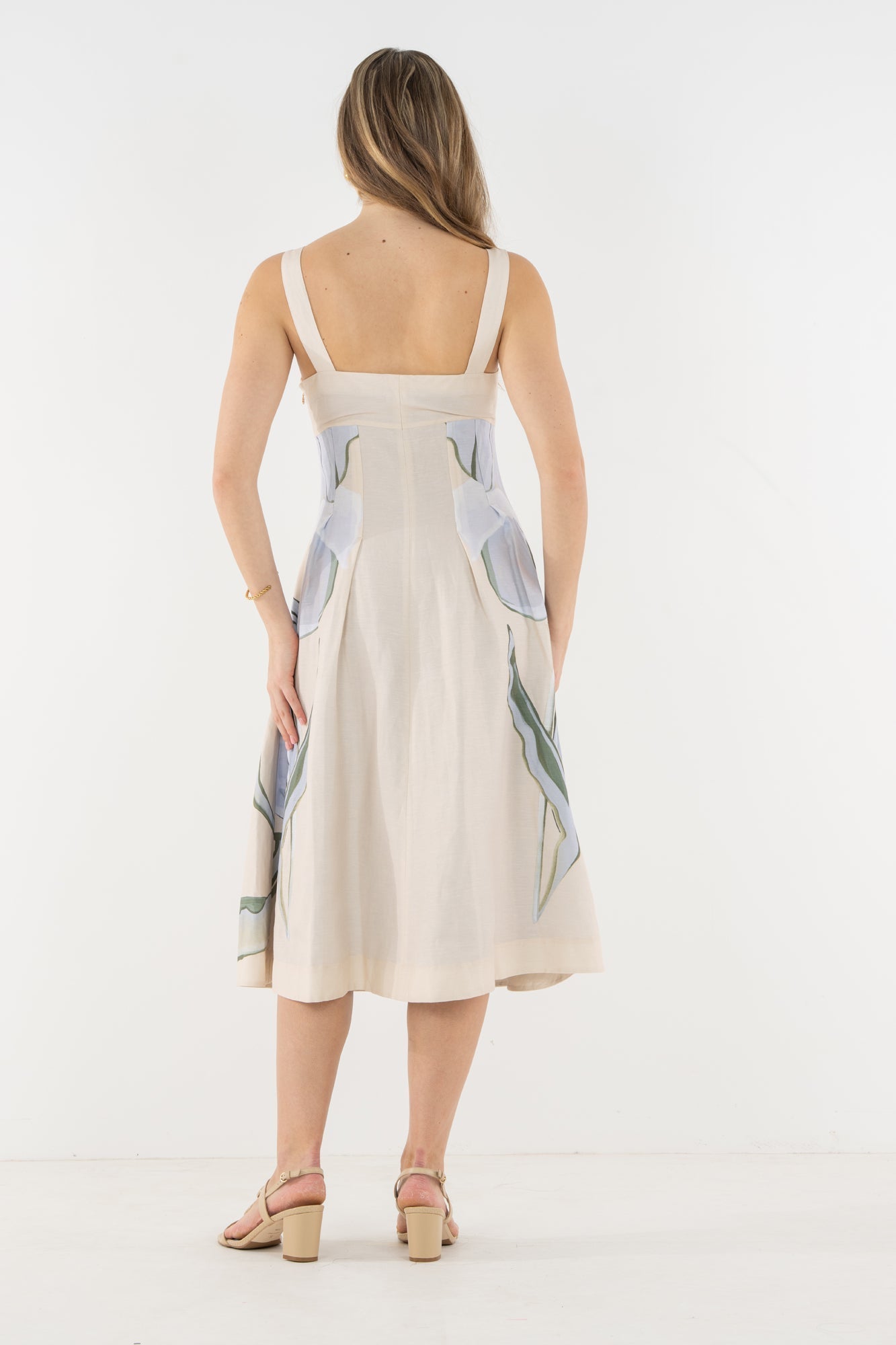 Back view of a model wearing the Emily McCarthy Constance Midi Dress in the Lavender Fields print.