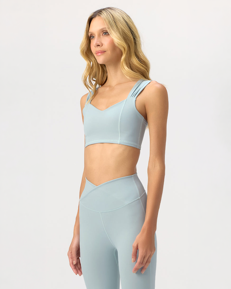 Model wearing the Glee x Be Fit Enchanted Sea Top in Sea Form, front view.