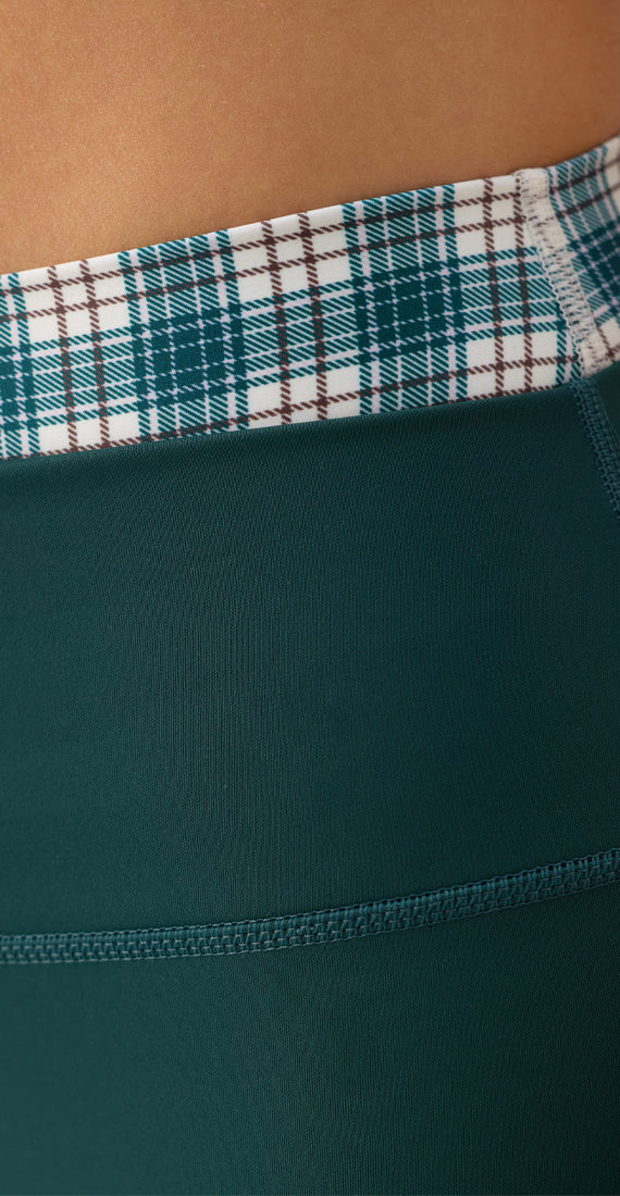 Close-up of the Be Fit x Glee Verdant Leggings featuring the plaid waistband, smooth fabric and seam detailing.