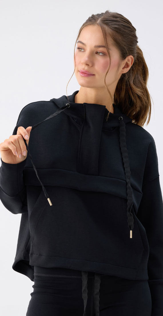 Close-up of the Be Fit x Glee black Onyx Raincoat featuring the high neckline, hood and adjustable braided drawstrings.