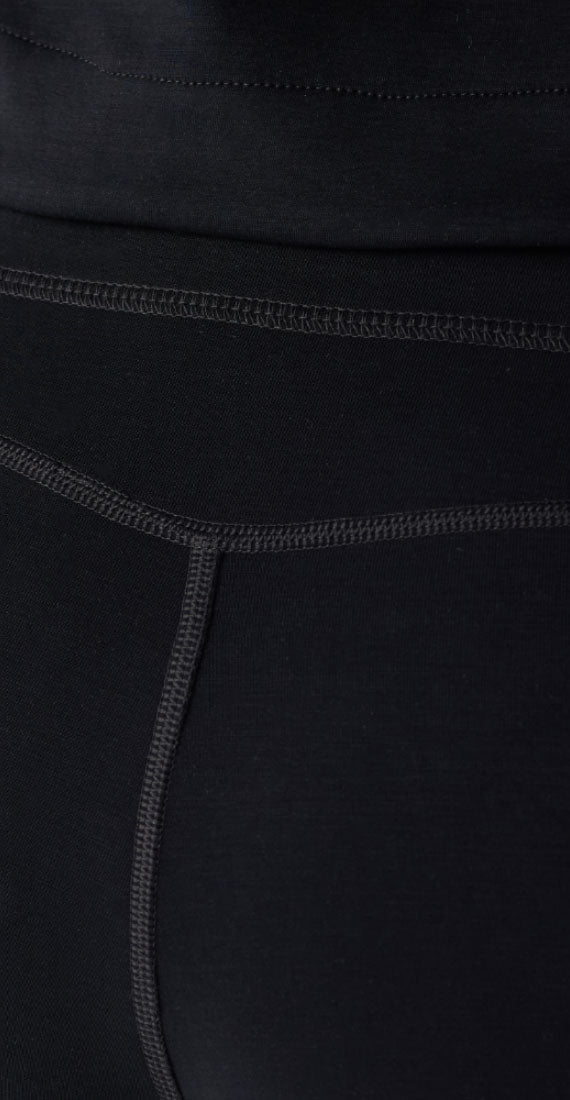 Close-up of the Be Fit x Glee back onyx waistband and curved seam detailing on the black flare leggings.