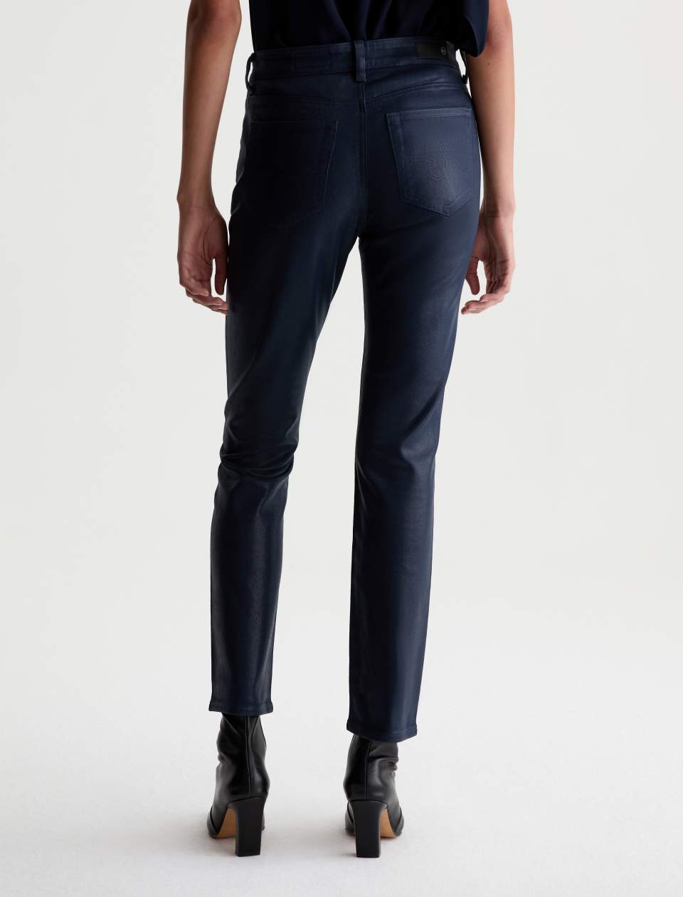 Back view of the AG Mari Coated Jean on a model, showing the rear pockets and straight-leg fit.