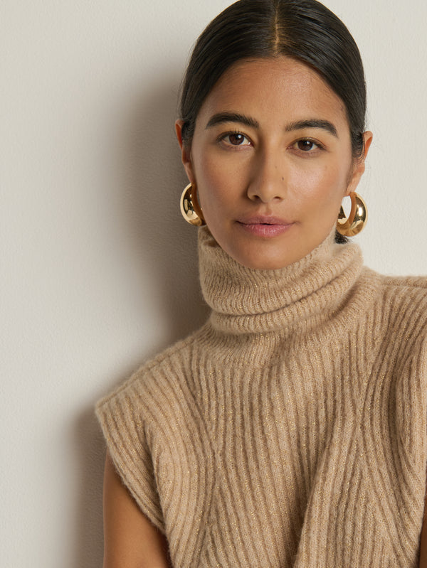 Close-up of the Nation Los Angeles Isha Turtleneck Tank in Shiny Moonbeam, highlighting the ribbed turtleneck neckline.