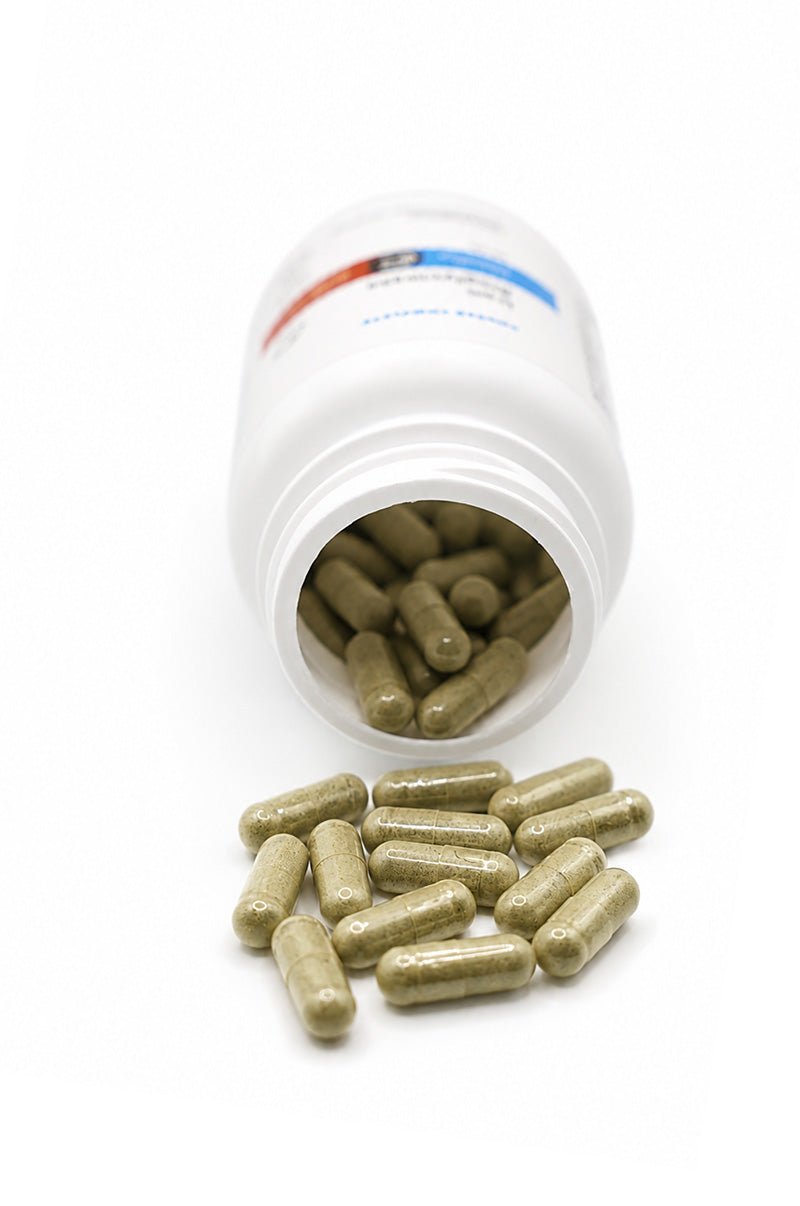 Open white Cooper Complete Iron Bisglycinate pill bottle with capsules spilling out on a white background