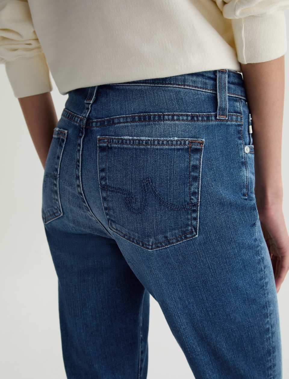 Close up back angled view of model wearing Mari Crop Jean in 15 Years Prague by AG Jeans.