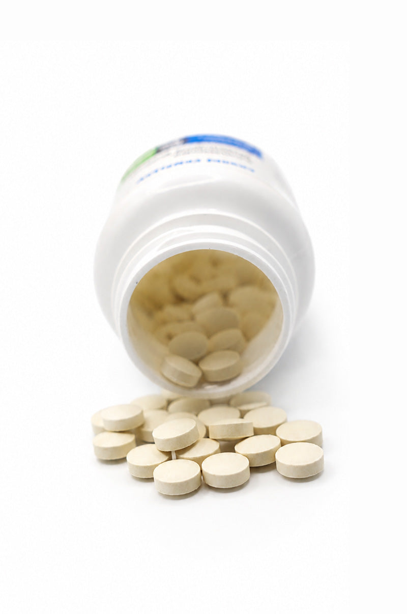 Open white Cooper Complete Prolonged Release Melatonin Supplement pill bottle with tablets spilling out on a white background