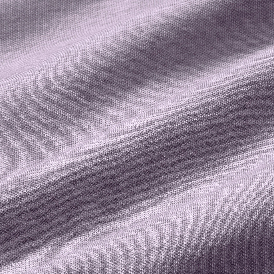 Fabric swatch of the Mizzen+Main KPI Quarter Zip in Purple Dusk Heather (lilac), showing the soft heathered four-way stretch performance fabric.