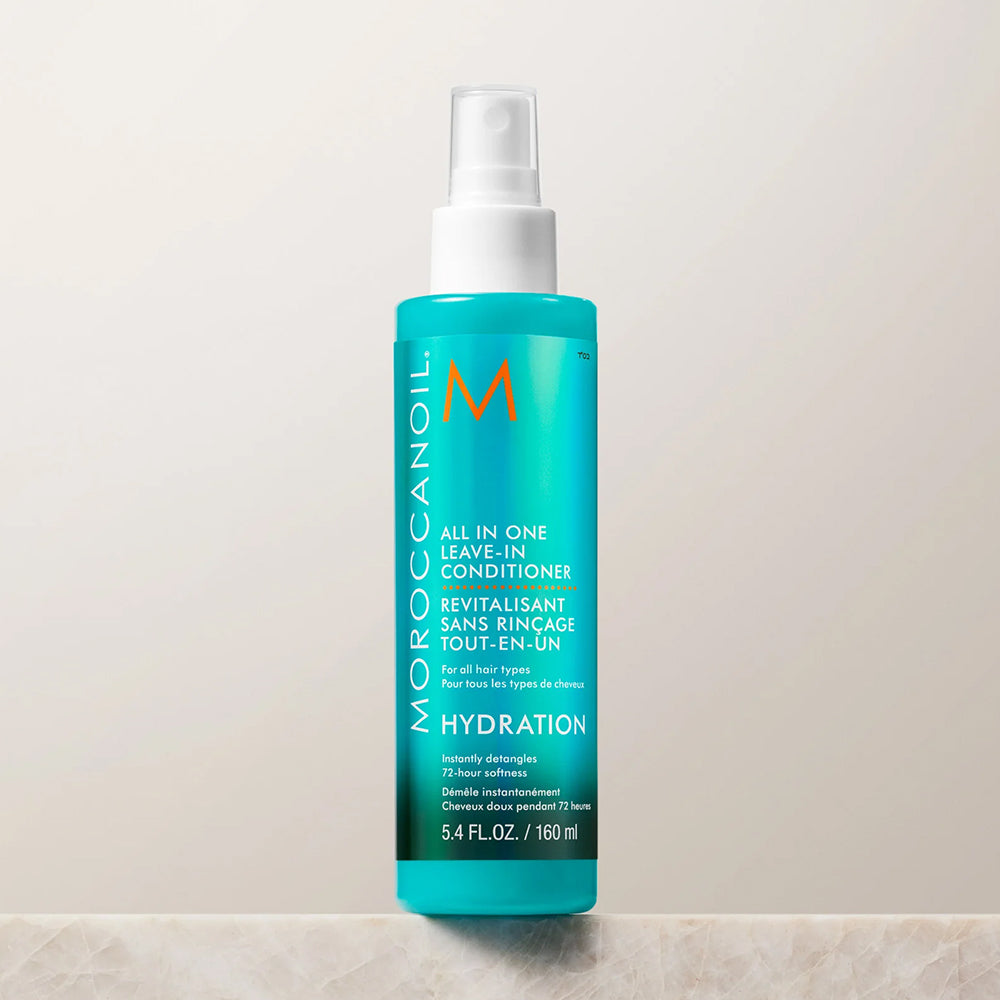 Turquoise spray bottle of Moroccanoil All In One Leave-In Conditioner for all hair types for detangling and softness, 5.4 fl oz.