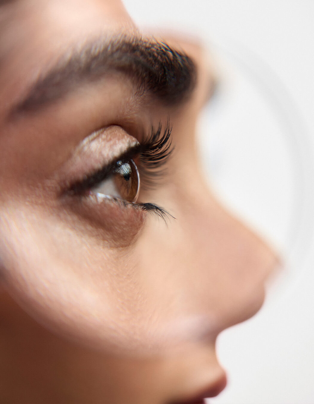 Close up of model with brown eyes wearing RevitaLash Length Define Tubing Mascara.