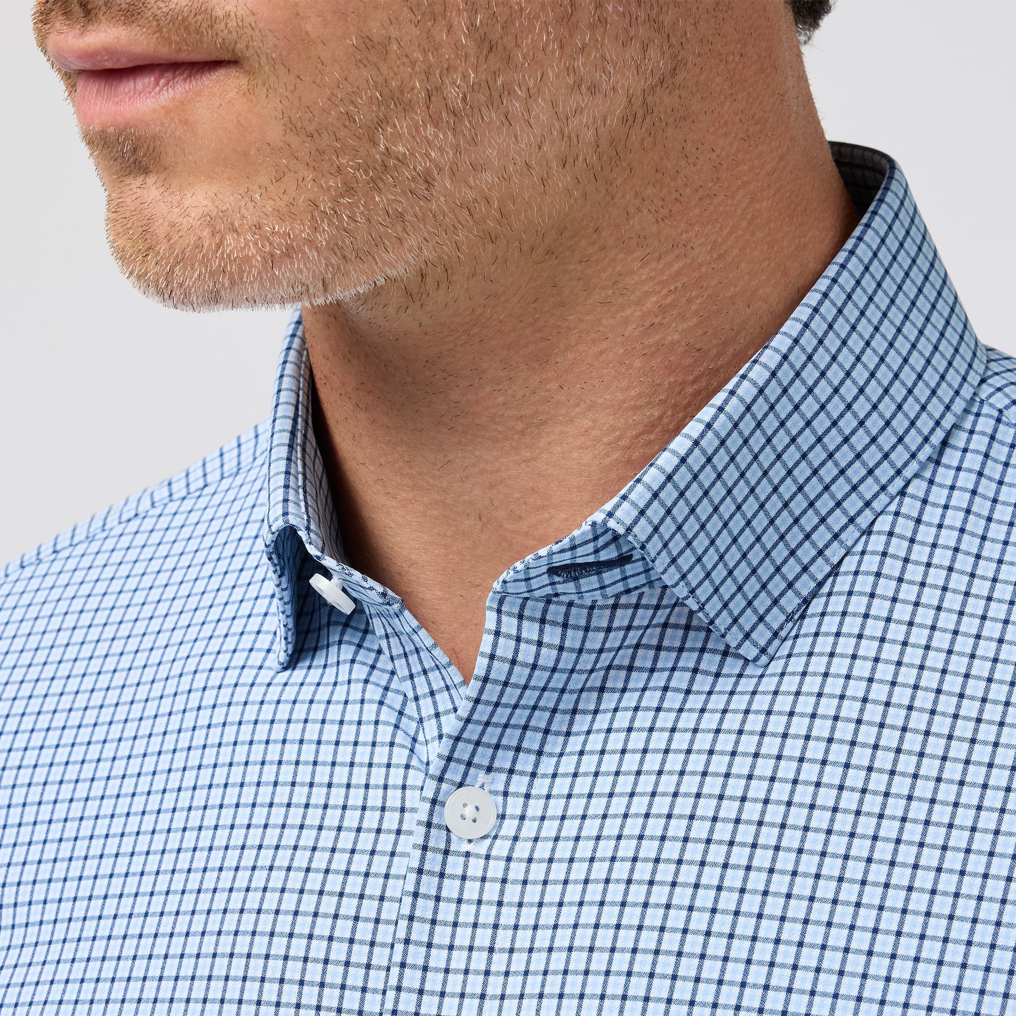 Close-up of the spread collar and neckline on the Mizzen+Main Leeward Long Sleeve Dress Shirt in Midnight Navy Sam Plaid (dark navy and blue plaid).