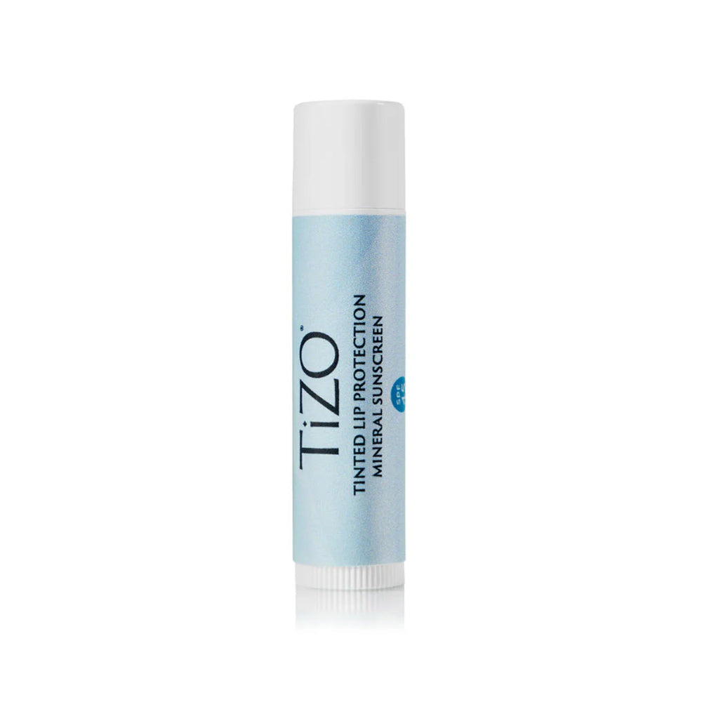 A light blue twist-up tube of Tizo Tinted Lip Protection Mineral Sunscreen lip balm with a white cap.