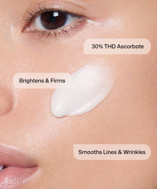 Close up of woman applying Revision Skincare C+ Correcting Complex with 30% THD ascorbate to brighten, firm, and smooth lines and wrinkles.