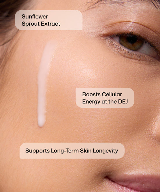 Close up of woman using Revision Skincare DEJ Daily Boosting Serum with sunflower sprout extract to boost cellular energy and support long-term skin longevity.