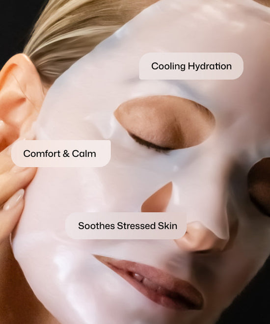 Close up of a model with Revision Skincare Hydrating Biocellulose Mask on for cooling hydration, comfort and calm, and soothing stressed skin.