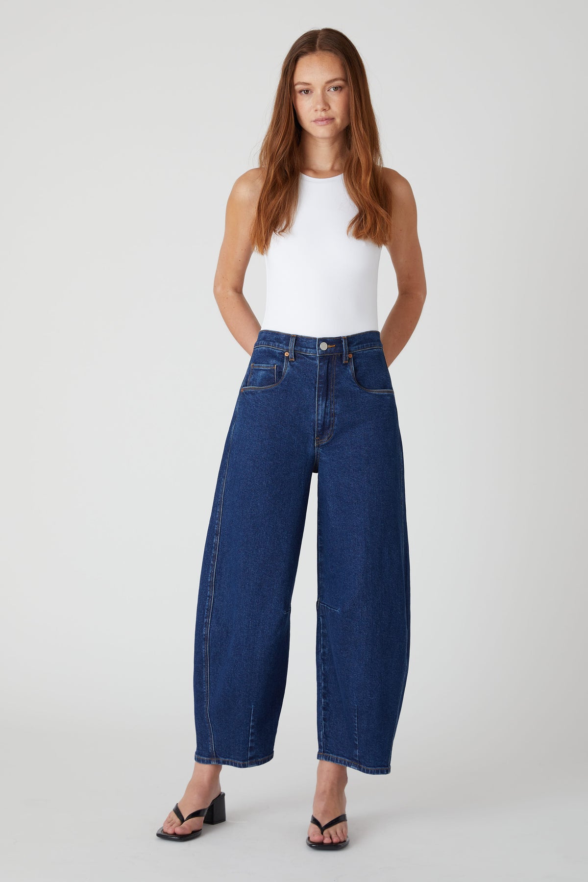 Model wearing the BLANKNYC Deep Down Barrel Jean in Dark Indigo, front view.