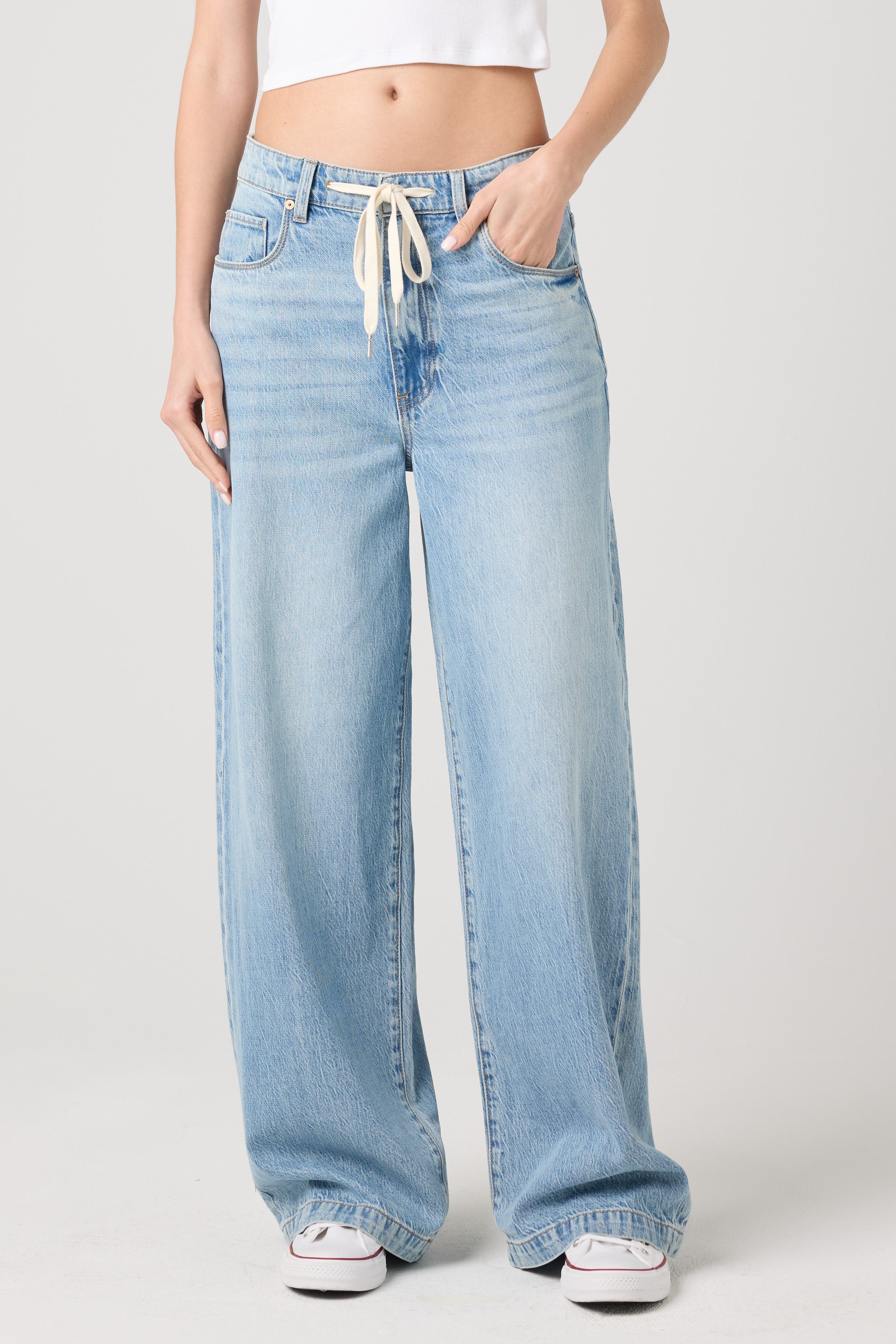 Model wearing the BLANKNYC Feeling Good Low-Rise Baggy Fit Denim Jean in Light Indigo, front view.