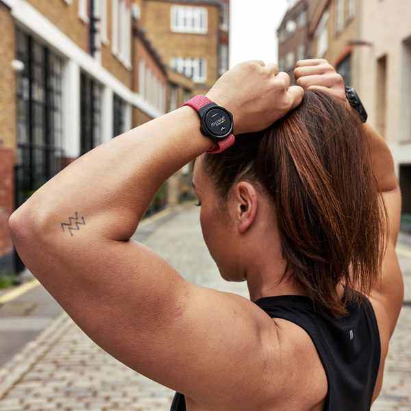 Close-up of the MYZONE MZ-Switch heart rate monitor on wrist of woman.