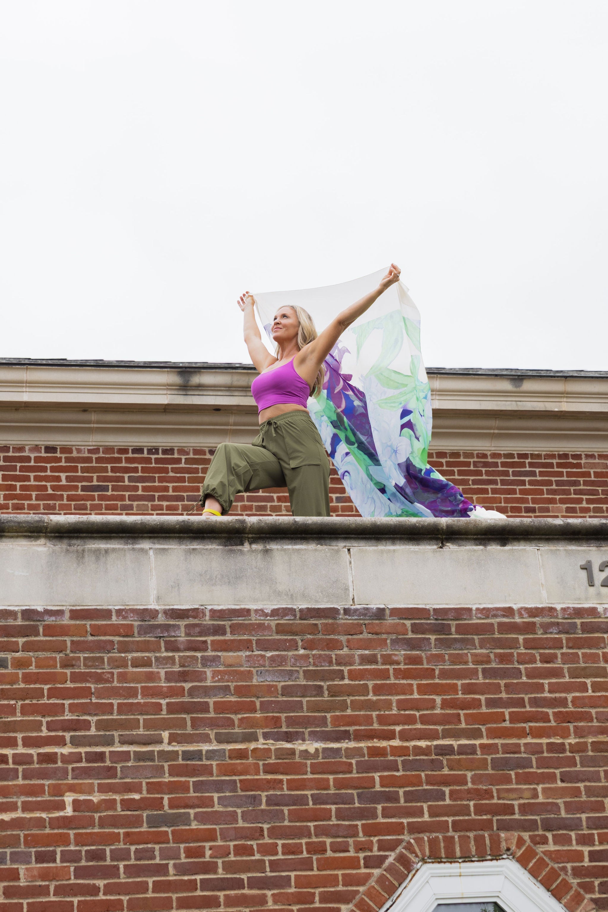 Model wearing the Be Fit Convertible Cargo Pant in green, side view.