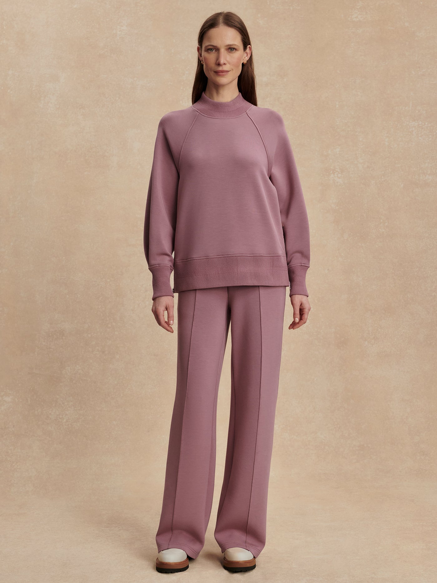 Model wearing the Varley The Wide Leg Pant 30" in Wistful Mauve, front view.