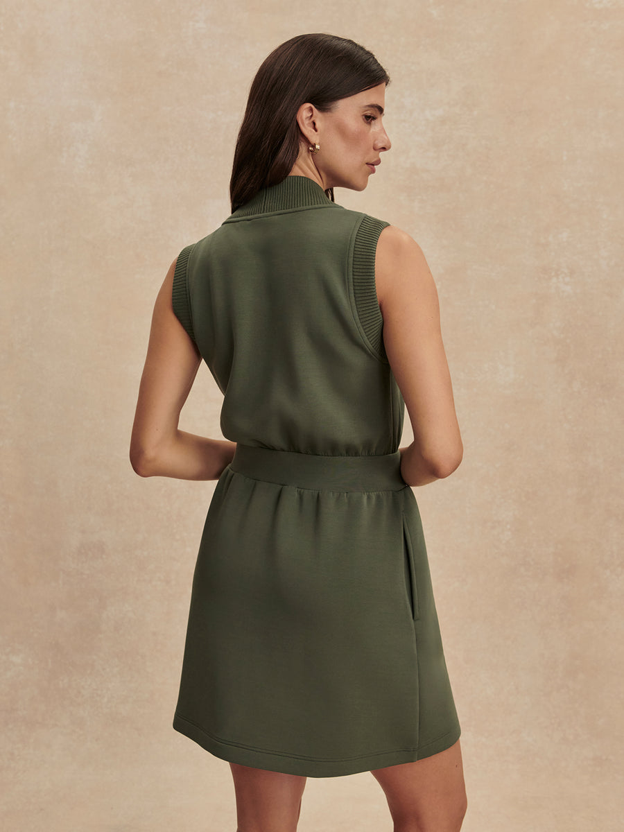 Back view of a model wearing the Varley Polyanna Half-Zip Dress in Thyme.