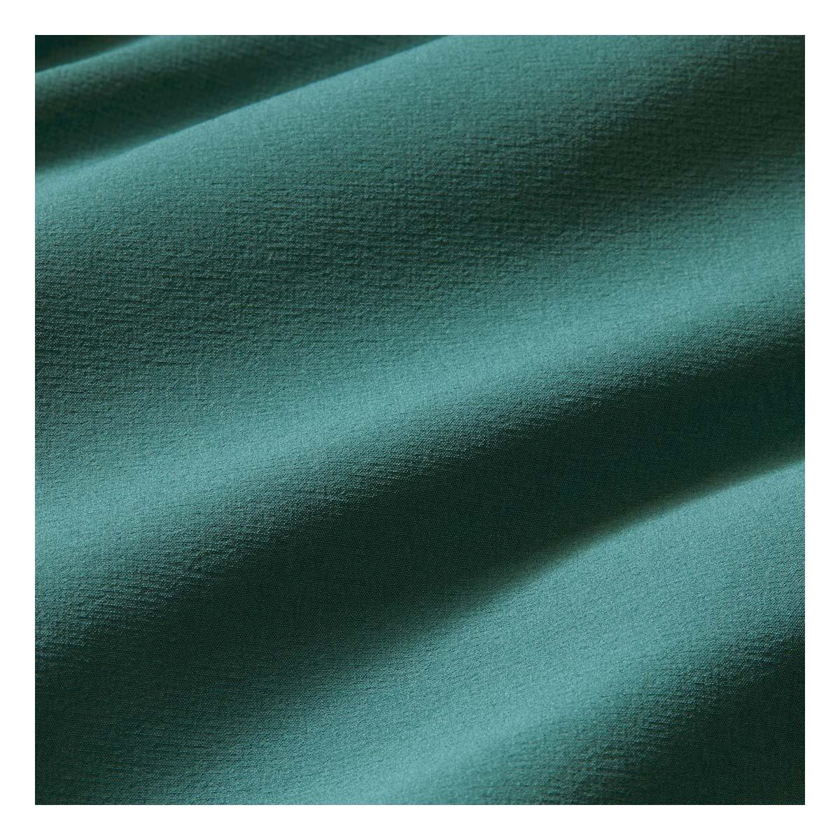 Close-up of the Mizzen+Main Helmsman Short performance fabric in Balsam (deep green), highlighting the lightweight woven texture.