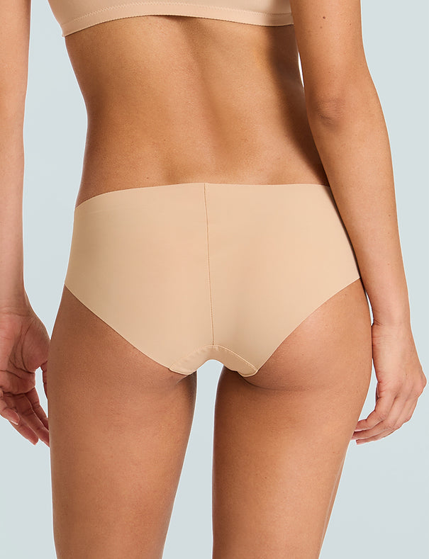 Trunk back view of a model wearing the Commando Classic Bikini Brief in nude.