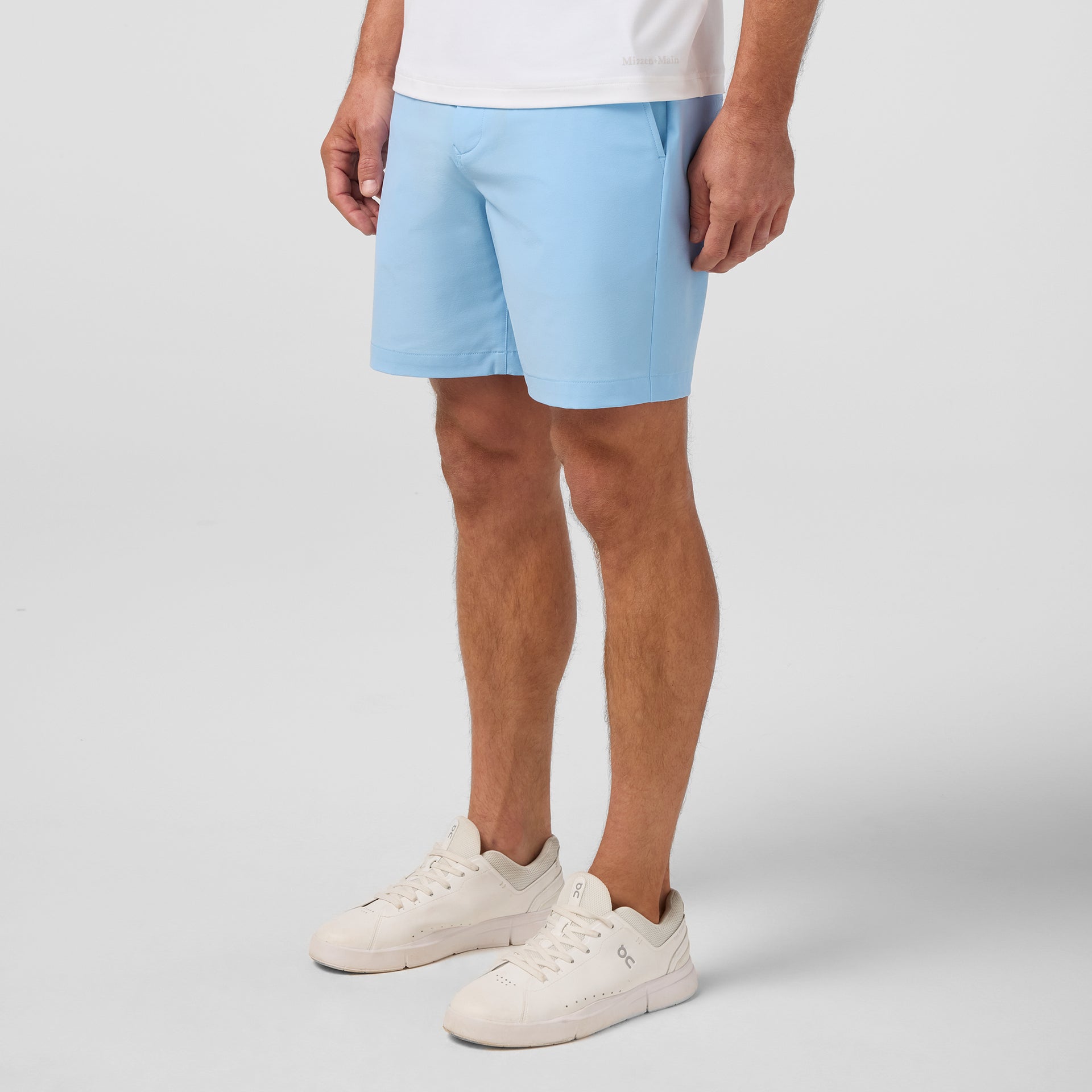 Sideview of a model wearing the Mizzen+Main Helmsman Short in Cloud Blue (light blue).