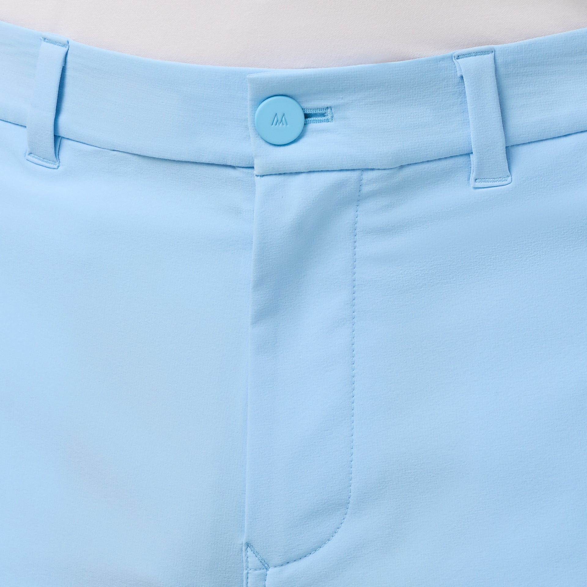 Close-up of the front zipper and button detail on the on the Mizzen+Main Helmsman Short in Cloud Blue (light blue).
