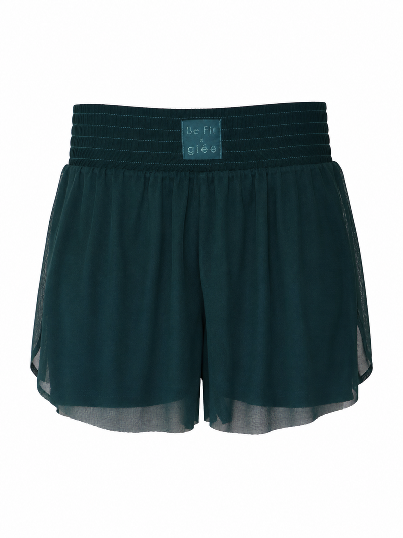 Front view of the Be Fit x Glee botanic green Ballerina Mesh Shorts with a wide textured waistband, layered mesh fabric and curved side hems.