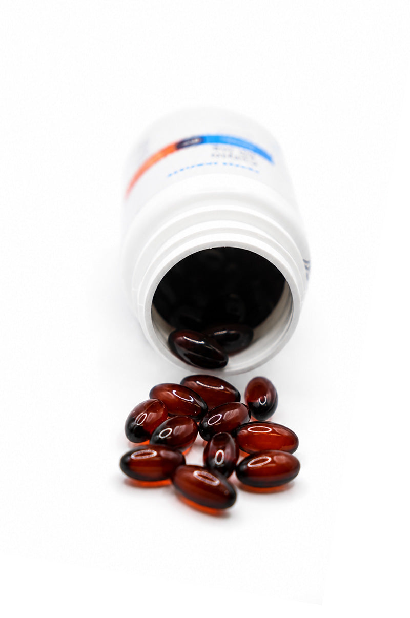 Open white Cooper Complete 50 mg CoQ10 Ubiquinol pill bottle with softgels spilling out on a white background