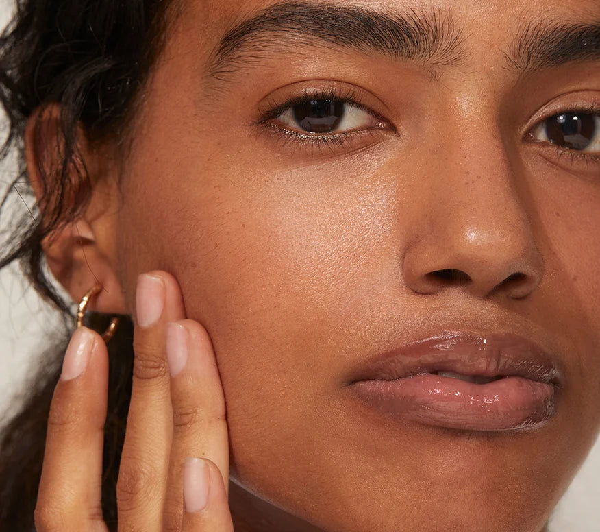 Close up of woman applying Ourself Daily Renewal Cream with hyaluronic acid. 