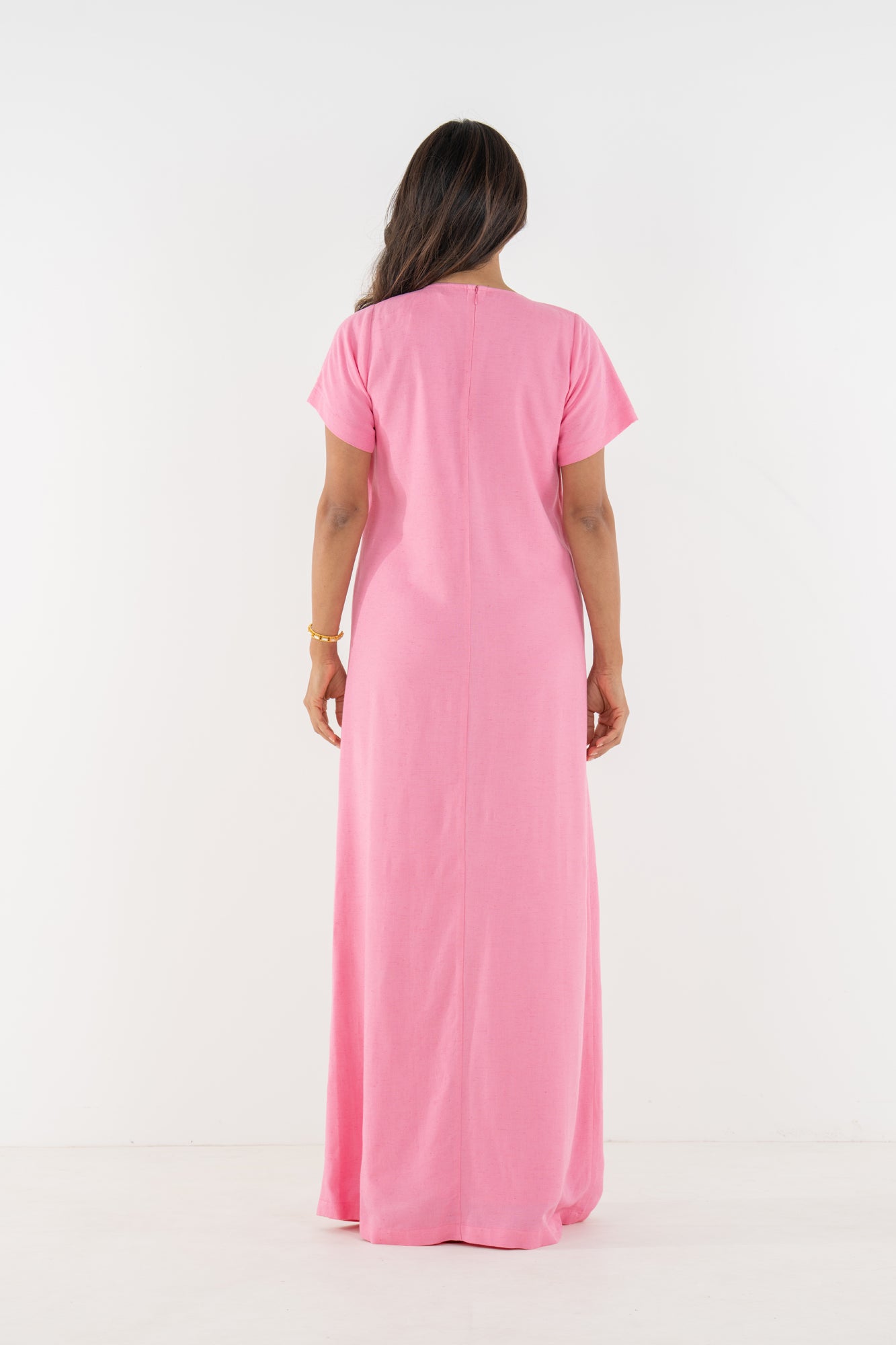 Back view of a model wearing the Emily McCarthy Cornelia Dress in Rosé.