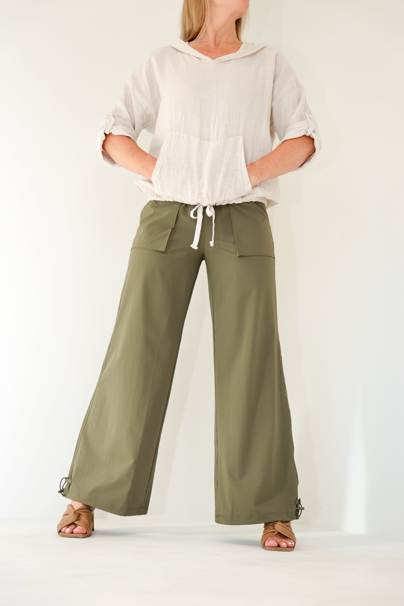 Model wearing the Be Fit Convertible Cargo Pant in green, front view.