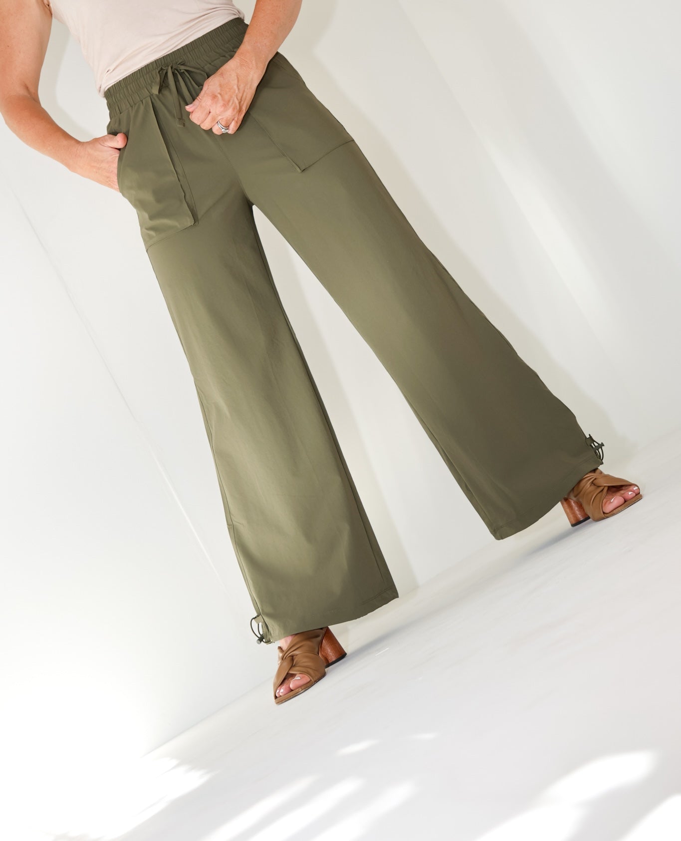 Model wearing the Be Fit Convertible Cargo Pant in green, front view.