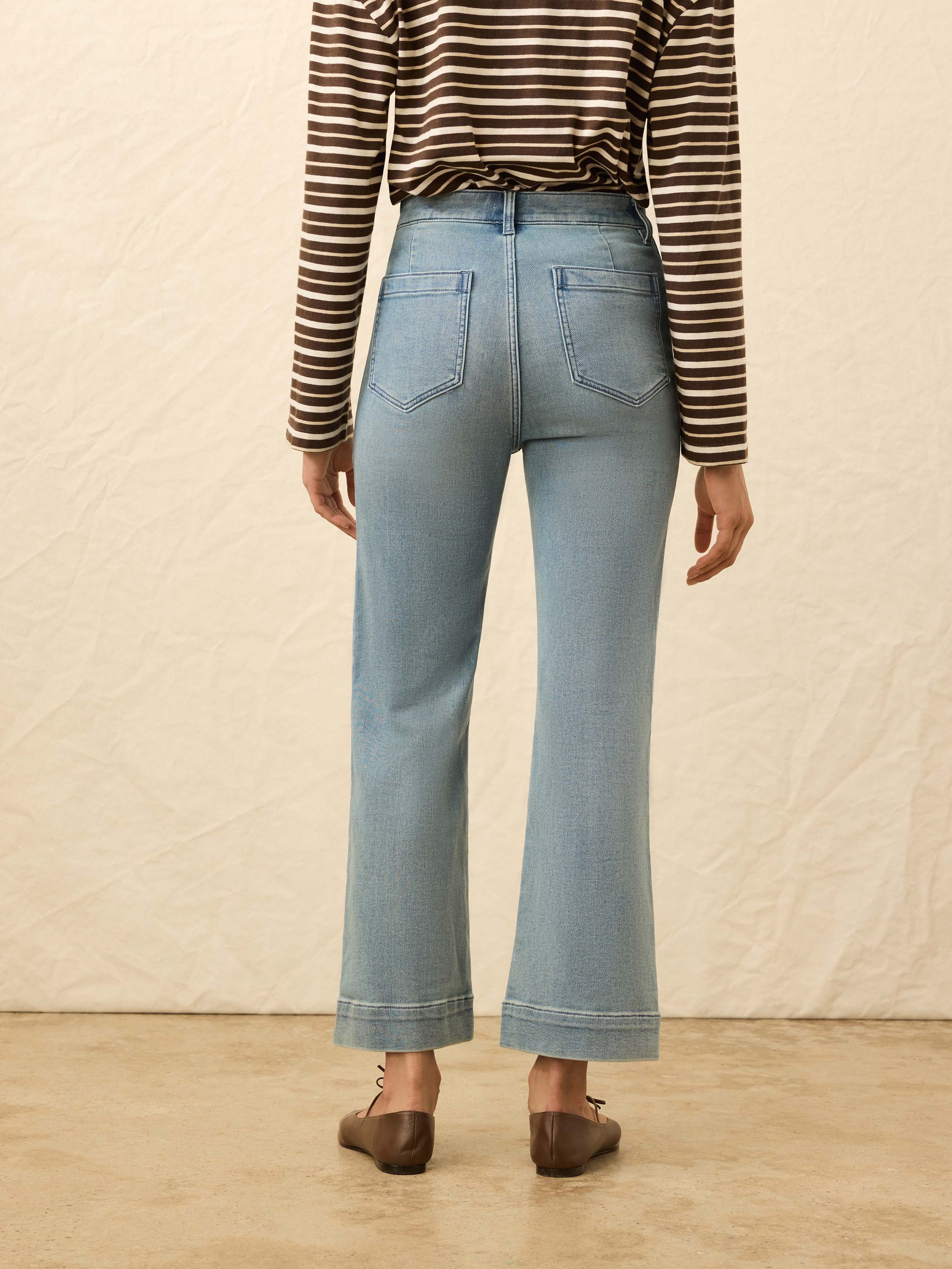 Back view of a model wearing the Faherty Stretch Terry Patch Pocket Ankle Pant in Eastern Shore Wash.