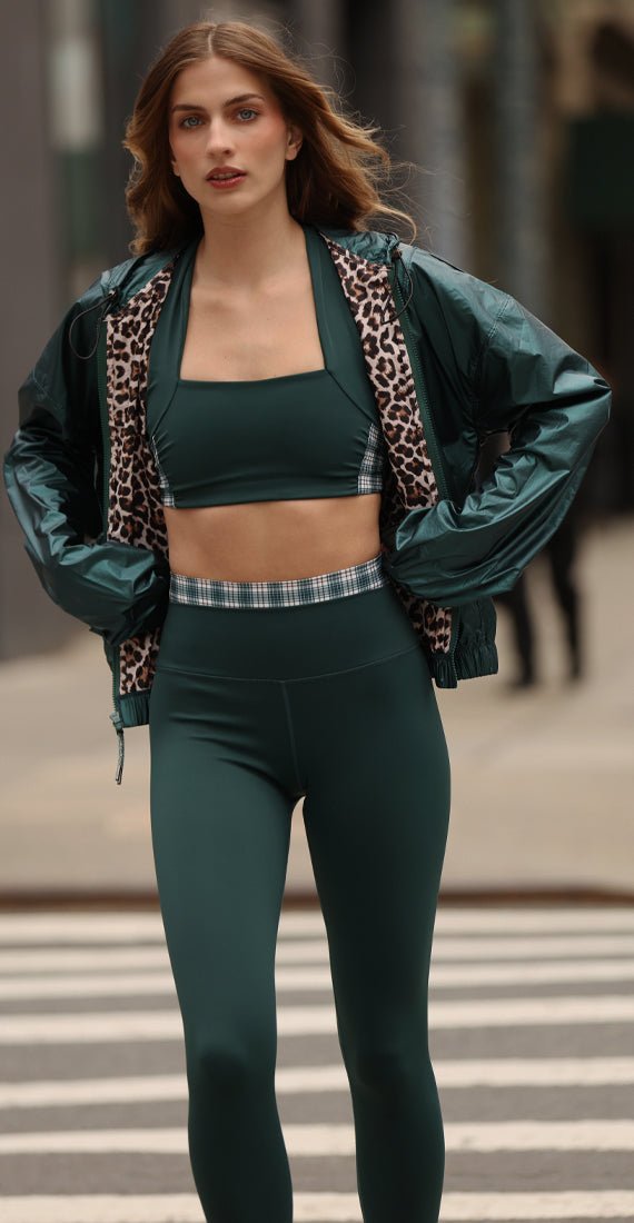 Front view of model wearing the Be Fit x Glee Botanic Green Verdant Leggings with a matching crop top and jacket outdoors.