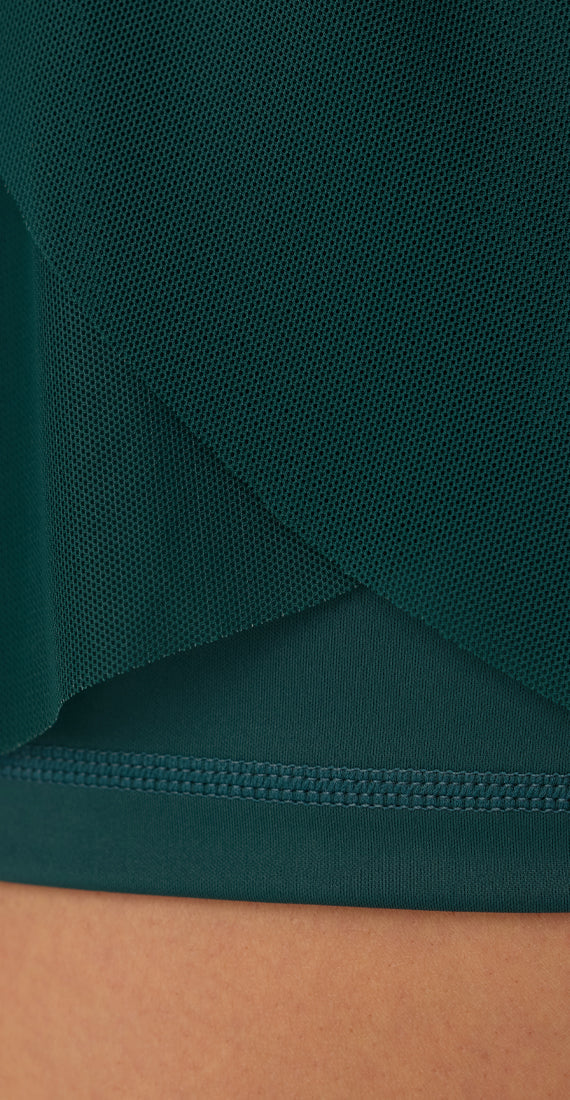 Close-up of the layered mesh fabric and solid inner lining of the Be Fit x Glee botanic green Ballerina Mesh Shorts.