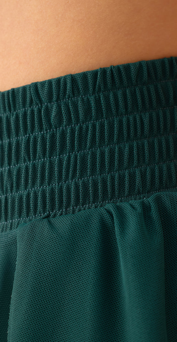 Close-up of the textured elastic waistband and gathered mesh fabric on the Be Fit x Glee Ballerina Mesh Shorts.