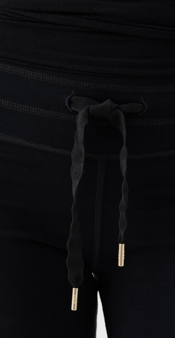 Close-up of the Be Fit x Glee black onyx drawstring waistband with textured ties and gold-tone tips.