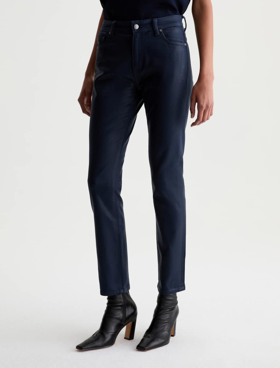 Angled front view of the AG Mari Coated Jean, showing its dark navy coated finish and tapered hem.