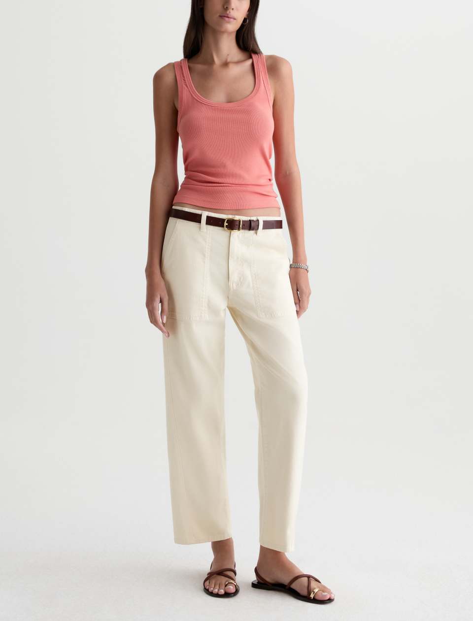 Model wearing the Analeigh Utility Pant with a pink tank, brown belt and sandals.